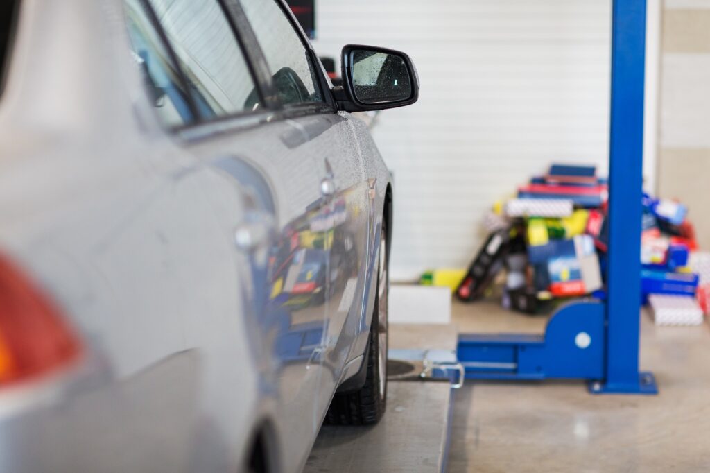 car on lift at repair station